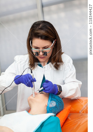Application of an anti-aging facial rejuvenation cocktail using micro needles. Dermatology concept. Aesthetic medicine concept. Application of an anti-aging facial rejuvenation cocktail using micro needles. Dermatology concept. Aesthetic medicine concept. 118344427