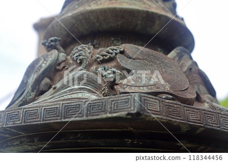 Turtle on the base of a bronze lantern on the approach to Tomonoura Numaname Shrine 118344456