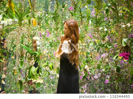 A girl stands in the center of an abundance of fresh flowers, Japan, TIMELAB 118344493