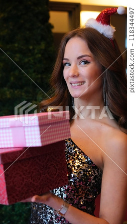 Girl holding a box with a gift red color Girl holding a box with a gift red color 118344497