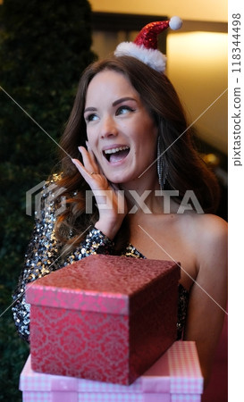 Girl holding a box with a gift red color 118344498