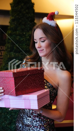 Girl holding a box with a gift red color Girl holding a box with a gift red color 118344502