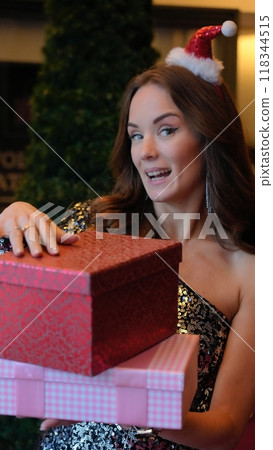 Girl holding a box with a gift red color 118344515