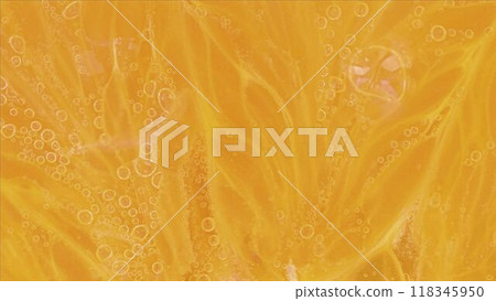 Slice an orange in bubble water. Slice of orange in carbonated water. Party concept, summer, holiday, birthday 118345950