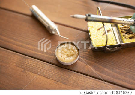 Soldering iron placed on the iron stand 118346779