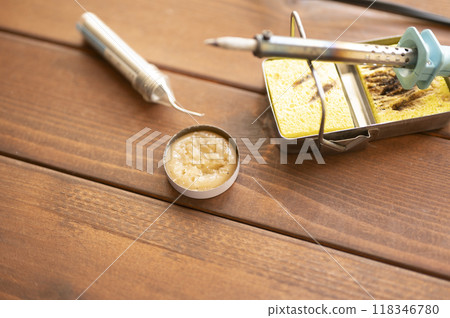 Soldering iron placed on the iron stand 118346780