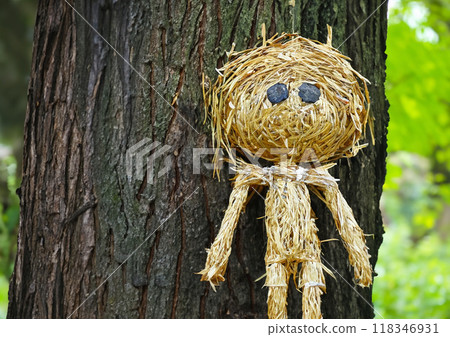 Image of a straw doll nailed to a tree 118346931