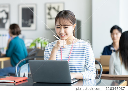 Young female engineer working in an office Young female engineer working in an office 118347087