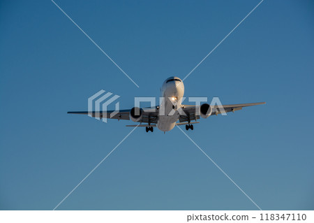 A jet plane preparing to land in the sunlight A jet plane preparing to land in the sunlight 118347110