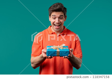 Excited Man Hold Gift Box With Bow. He Is Happy And Flattered By Attention. Guy Excited Man Hold Gift Box With Bow. He Is Happy And Flattered By Attention. Guy 118347158
