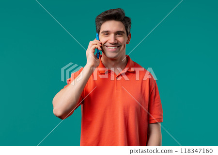 Smiling positive man talking by phone, smiling. Mature guy on blue background. 118347160