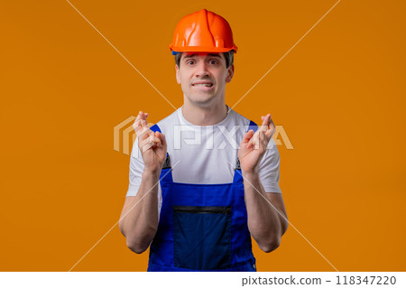 Mature construction builder man praying on orange studio. Hopeful Prayer, belief 118347220