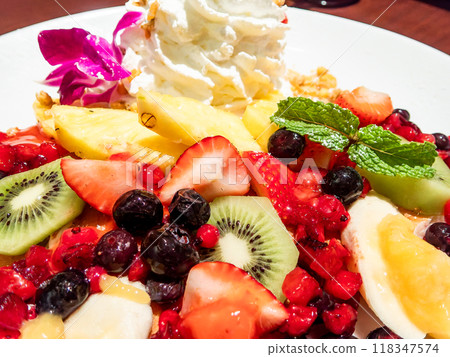 Delicious pancakes topped with fruit Delicious pancakes topped with fruit 118347574