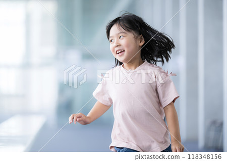 Bright image of children walking and running through school building 118348156