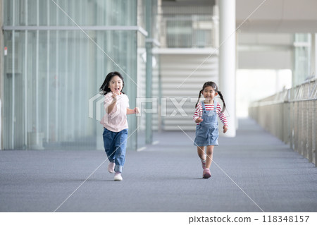 Image of children classmates running and walking through school building 118348157