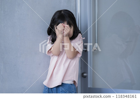 Image of a child hiding their face in shock, bullying, etc. 118348161
