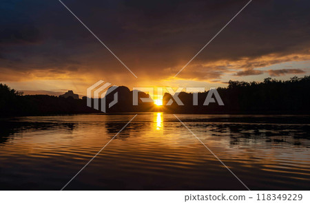 Beautiful sunrise behind the island ridge. Beautiful sunrise behind the island ridge. 118349229