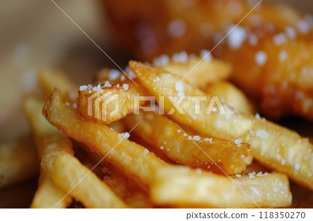 Crispy French Fry with Salt Crystals and Chicken Finger in Background 118350270