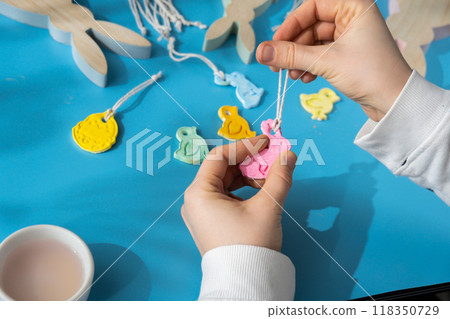 Unrecognizable artist do it yourself air dry clay crafts for Easter holiday. Decoration gift idea Handmade children craft. Step by step instruction of painting, pressing figures 118350729
