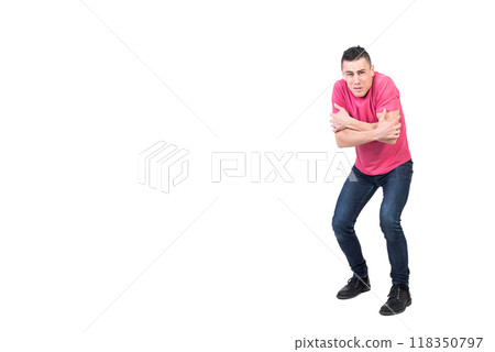 Shivering man standing in studio with crossed arms Shivering man standing in studio with crossed arms 118350797
