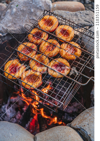 grilled peaches cooking over an open flame caramelized texture, vibrant colors 118351159