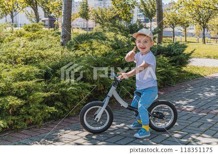 A playful little boy poses for a photo on a walk with his dad A playful little boy poses for a photo on a walk with his dad 118351175