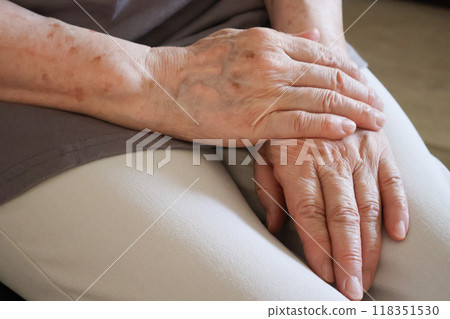 The hands of an elderly woman with her hands folded The hands of an elderly woman with her hands folded 118351530