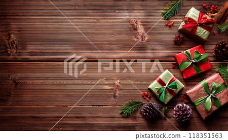 Christmas gifts and pine cone decorations that stand out against a wood grain background: background material 118351563