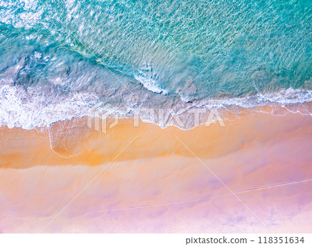 Top view waves crashing on sandy shore, Beach sea space nature background Top view waves crashing on sandy shore, Beach sea space nature background 118351634
