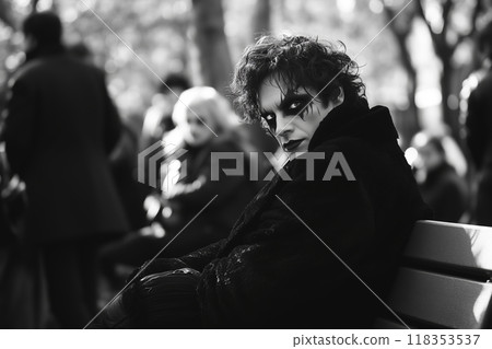 A solitary vampire enjoys a quiet moment on a park bench under the golden glow of autumn leaves during early evening hours 118353537