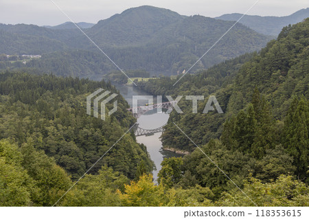 A train crossing the Tadami River No. 1 Bridge amid fresh greenery A train crossing the Tadami River No. 1 Bridge amid fresh greenery 118353615