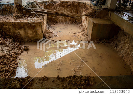 Large pile of earth in which there are many metal reinforcement bars 118353943