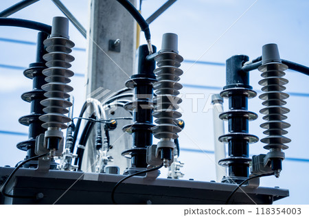 Various electrical equipment is set against a bright blue sky Various electrical equipment is set against a bright blue sky 118354003