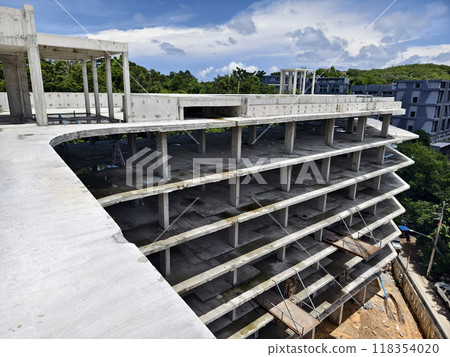 Large building with a roof pool of water under construction 118354020