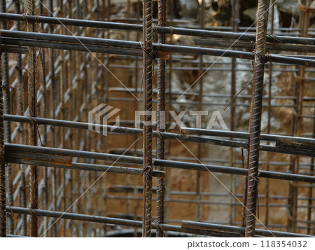 A construction site displaying a reinforced concrete foundation with steel rebar 118354032