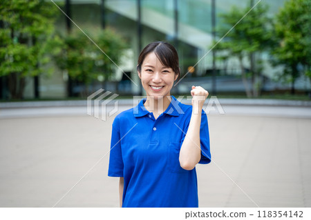 Motivated female nursing care facility staff with fist pump 118354142