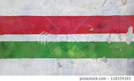A green and red striped wall with a white stripe The wall is covered in graffiti. A green and red striped wall with a white stripe The wall is covered in graffiti. 118354163
