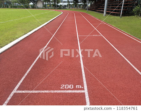 The running track inside a football stadium is usually a circular pathway surrounding the field 118354761