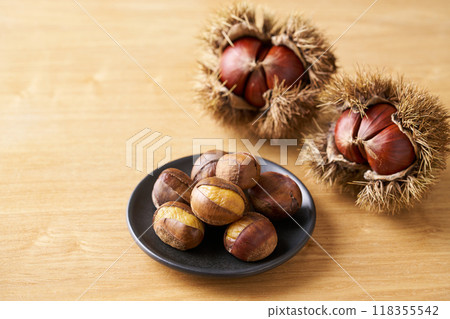 Roasted chestnuts on a plate Roasted chestnuts on a plate 118355542
