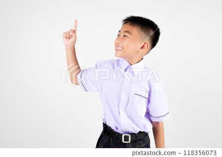 Portrait smile Asian little boy primary posing point finger to side away studio isolated white background, happy cute man kid wear school uniform plaid innocence and curiosity, back to school concept Portrait smile Asian little boy primary posing point finger to side away studio isolated white background, happy cute man kid wear school uniform plaid innocence and curiosity, back to school concept 118356073