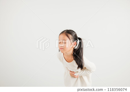 Portrait of Asian young kid girl has stomachache, kindergarten child abdominal pain suffering from stomach ache, studio shot isolated on white background, food poisoning, Health and medical gastritis Portrait of Asian young kid girl has stomachache, kindergarten child abdominal pain suffering from stomach ache, studio shot isolated on white background, food poisoning, Health and medical gastritis 118356074
