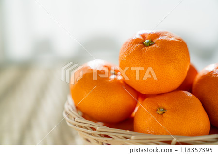 Mandarin oranges in a basket Mandarin oranges in a basket 118357395