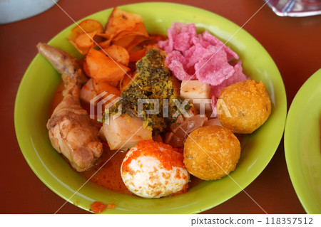 A colorful Lontong Padang dish featuring rice cake, chicken. A colorful Lontong Padang dish featuring rice cake, chicken. 118357512