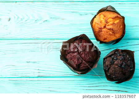 Mix of muffins ( cupcake ) chocolate , vanilla , berries . Top view 118357607