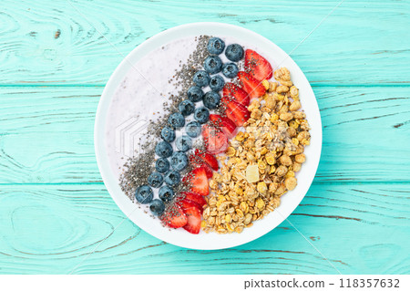 Healthy breakfast . Yogurt with berries ( strawberry , raspberry , blueberry , blackberry ) , granola and chia seeds . Top view 118357632