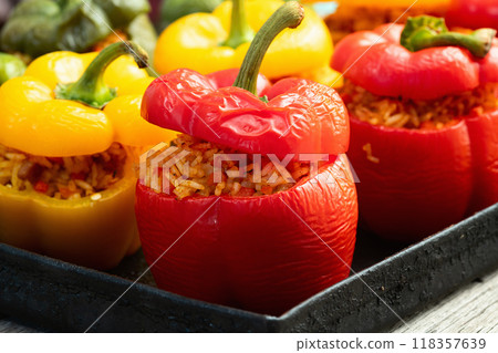 Baked stuffed pepper ( paprika ) with rice , carrot and meat . Top view on rustic background Baked stuffed pepper ( paprika ) with rice , carrot and meat . Top view on rustic background 118357639