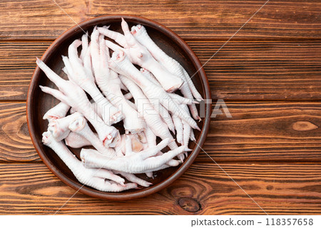 Raw chicken foot ( paws ) Top view on rustic background 118357658