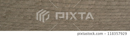 Earthy beige woven veneer surface with a tactile embossed texture 118357929