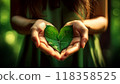 Hands of a Female Environmentalist Holding a Heart-Shaped Green Leaf - Generative Ai 118358525