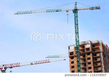 Large construction high rise crane, clear blue sky 118359007